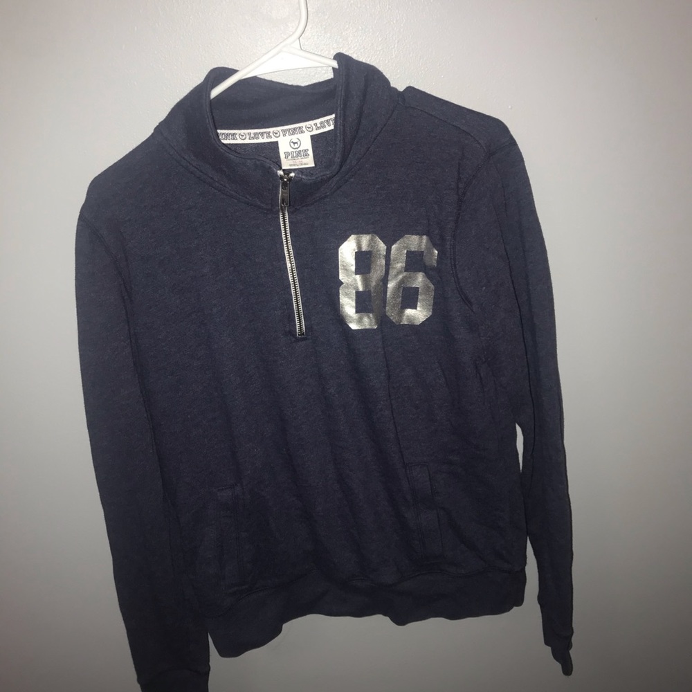 Pink semi-fitted quarter zip sweater.